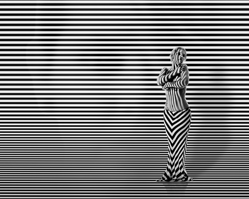 Woman with stripes and hidden face in background